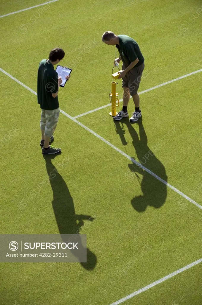 England, London, Wimbledon. Groundsmen conducting a bounce test on Court 8 in preparation for play at the 2011 Wimbledon Tennis Championships.