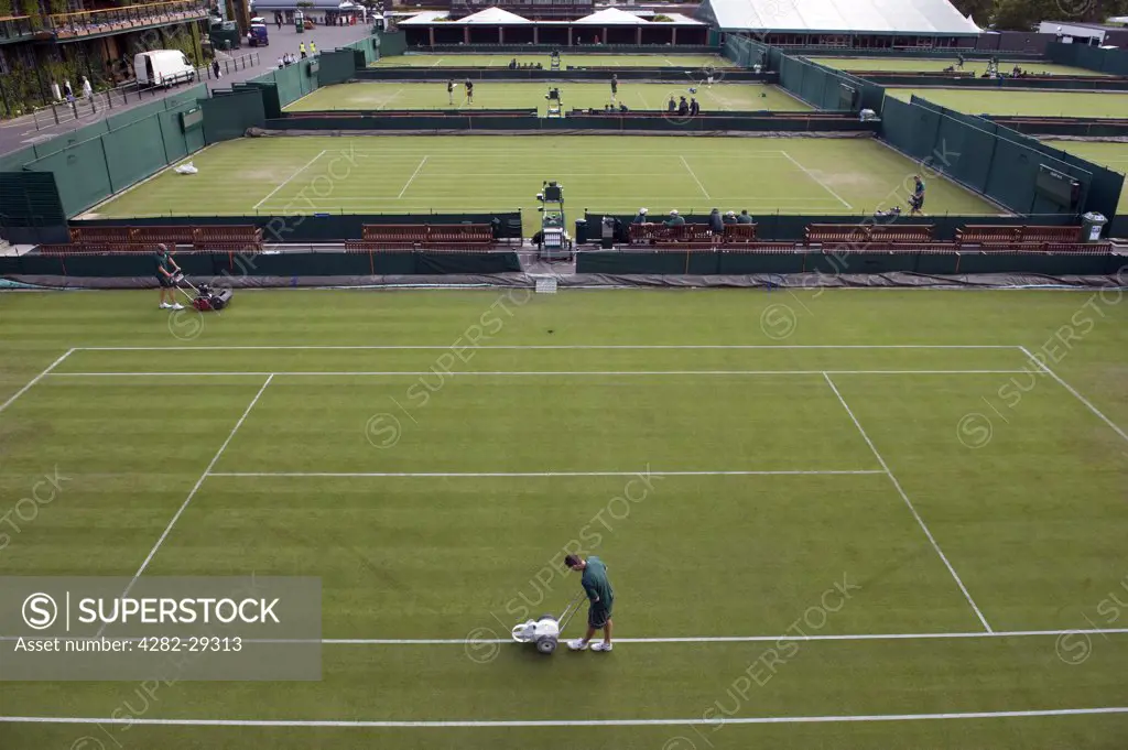 England, London, Wimbledon. Groundsmen preparing the outside courts for play at the 2011 Wimbledon Tennis Championships.