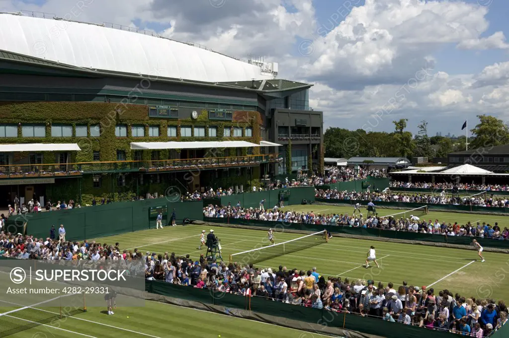 England, London, Wimbledon. Action on the outside courts with Centre Court in the background at the 2011 Wimbledon Tennis Championships.