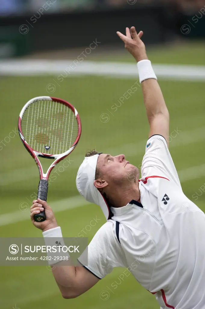 England, London, Wimbledon. Lleyton Hewitt (AUS) serving in a match at the 2011 Wimbledon Tennis Championships.