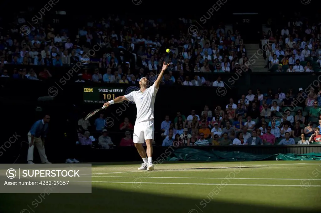 England, London, Wimbledon. Marcos Baghdatis (CYP) serving in a men's singles match at the 2011 Wimbledon Tennis Championships.