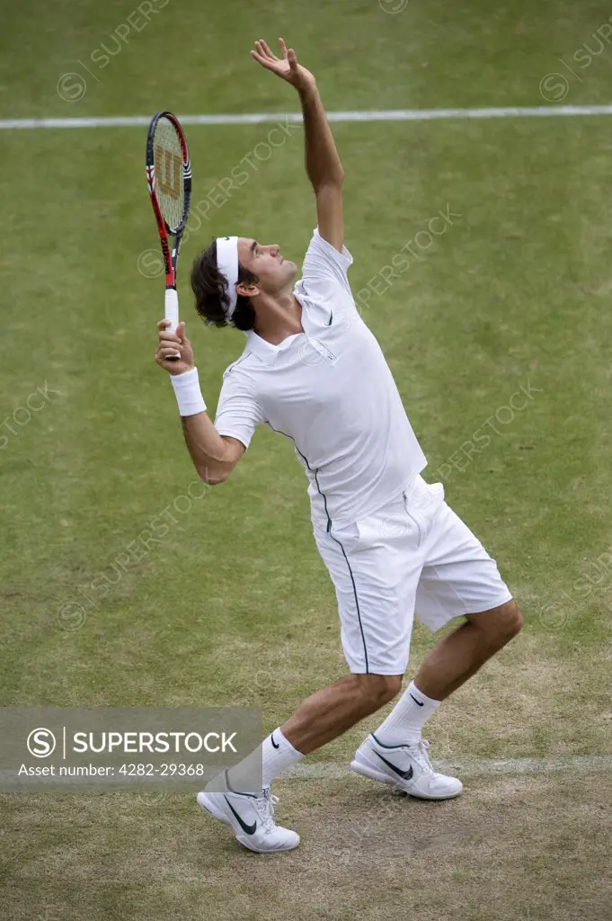 England, London, Wimbledon. Roger Federer (SUI) serving in a match at the 2011 Wimbledon Tennis Championships.