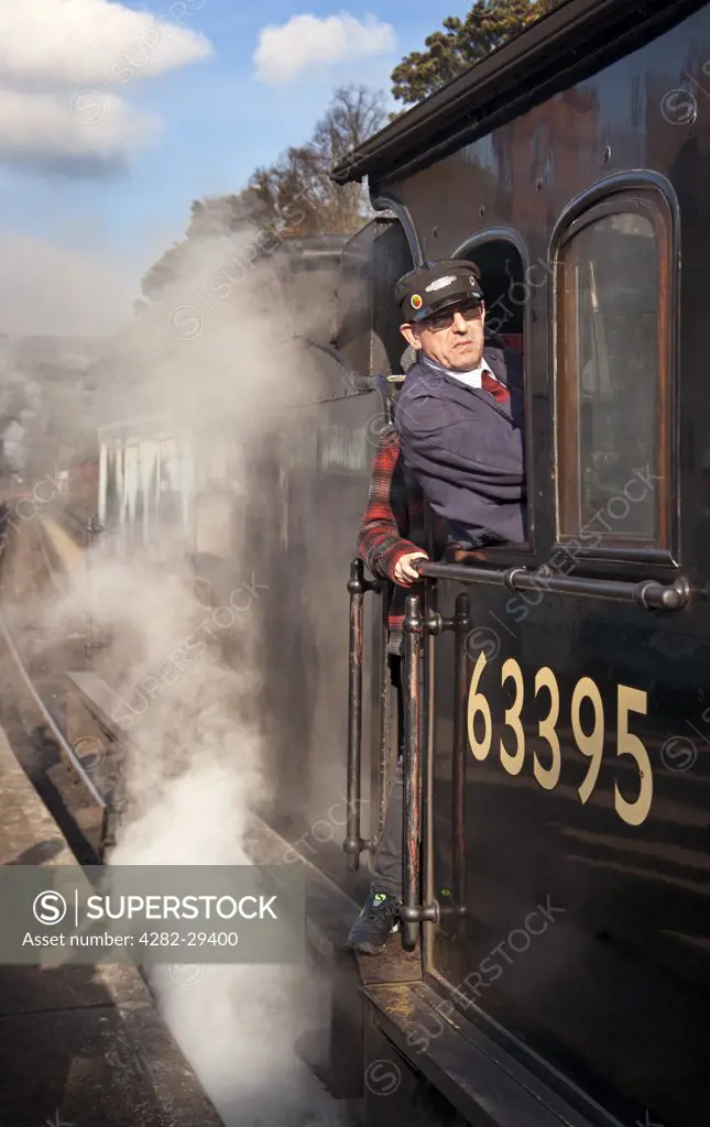 England, North Yorkshire, Grosmont. Steam Train and driver at Grosmont station on the North Yorkshire Moors Railway.