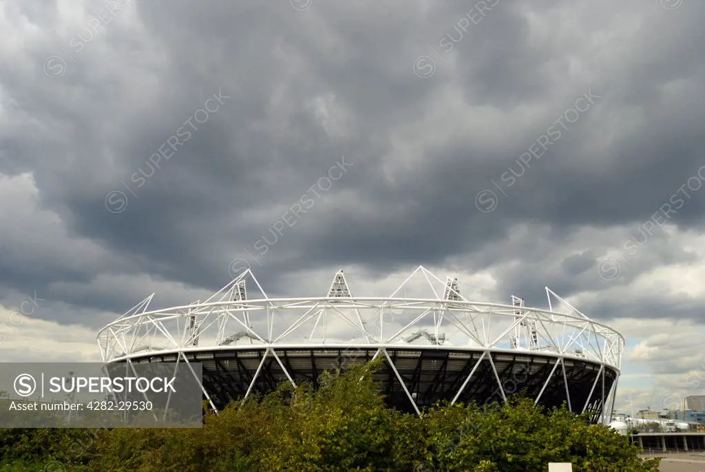 England, London, Stratford. Dark storm clouds over the 2012 Olympic Stadium.