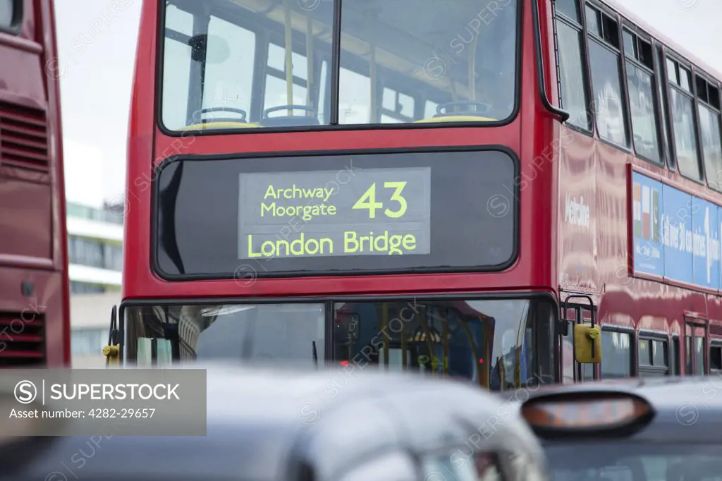 England, London, London Bridge. London taxis and a red double decker bus queuing on London Bridge.