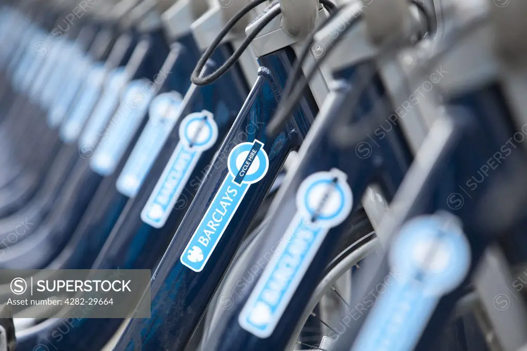 England, London, London. A row of Barclays Cycle hire scheme bikes in a docking station.