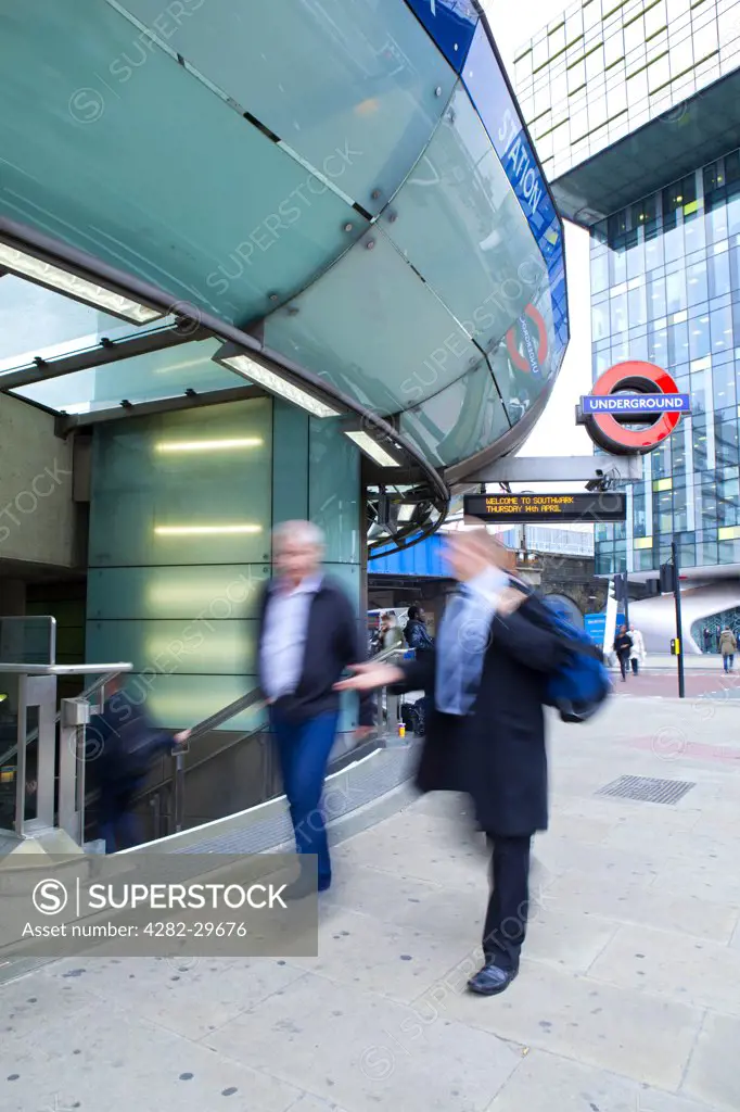 England, London, Southwark. People walking past the entrance to Southwark Underground Station.