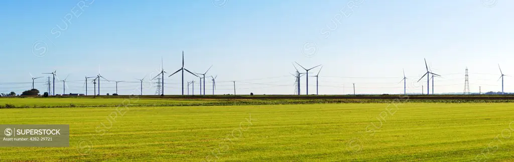 England, Kent, Romney. A panoramic view of the wind turbines and electricity cables near Romney Marsh.