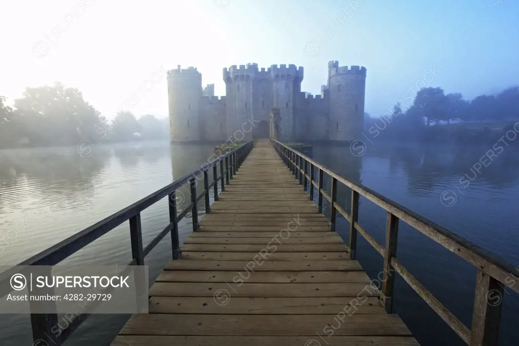 England, East Sussex, Bodiam. Wooden Bridge leading over the moat to Bodiam Castle, an almost perfect example of a 14th century medieval castle.