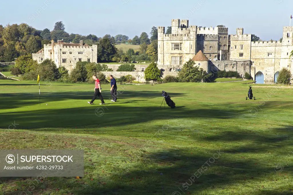 England, Kent, Leeds Castle. Golfers playing on the course at Leeds Castle.