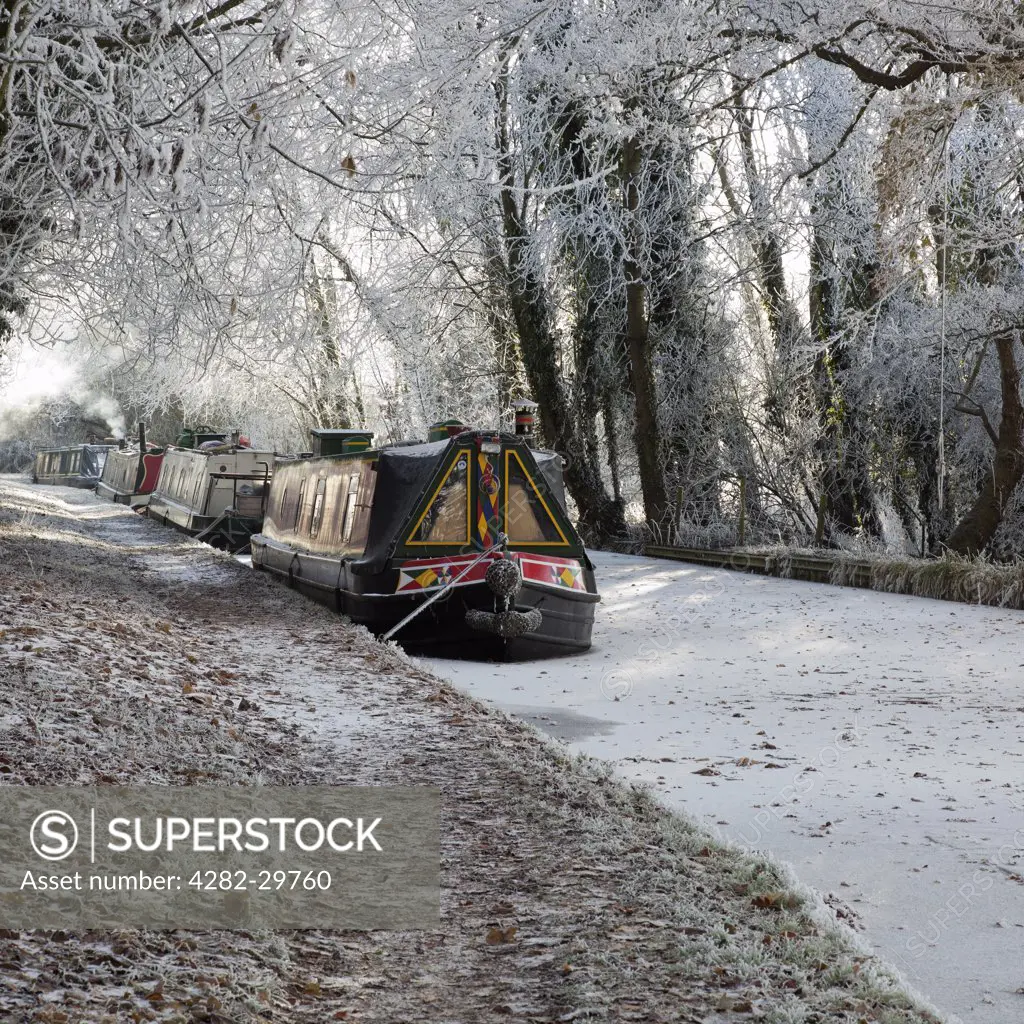 England, Northamptonshire, Welford. The Grand Union Canal at Welford has frozen around moored narrow boats.