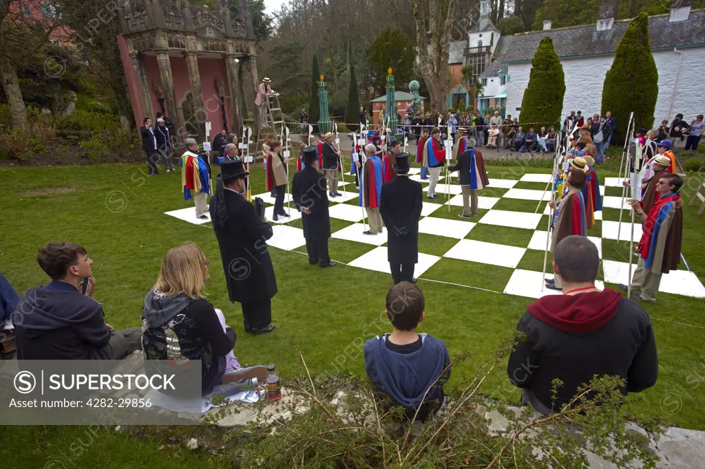Wales, Gwynedd, Portmeirion. Tourists watching a reenactment of a chess scene from the cult 1960s television show 'The Prisoner"" filmed in the popular Italian styled village of Portmeirion.