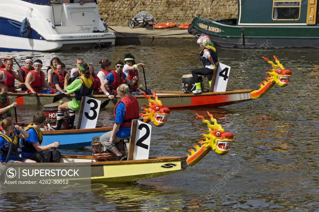 England, North Yorkshire, York. Boats preparing to compete in the Dragon Boat Challenge on the River Ouse in York.