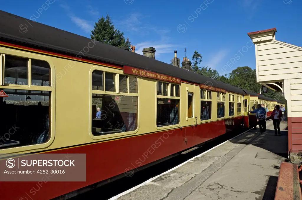 England, North Yorkshire, Goathland. Passengers boarding a train carriage at Goathland Station on the North Yorkshire Moors Railway.