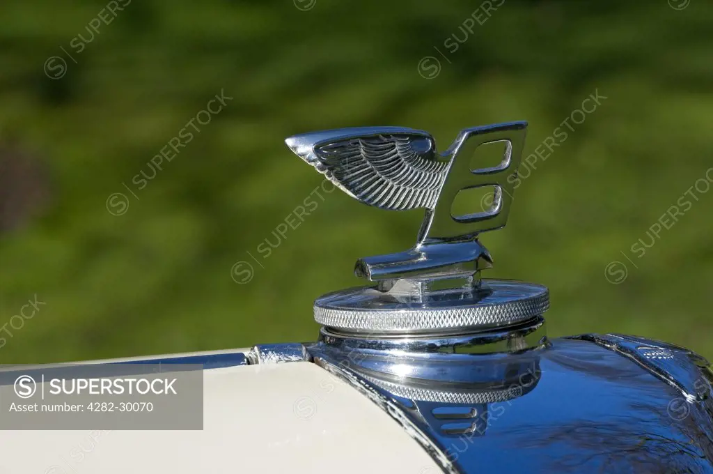 England. ""Flying B"" bonnet ornament on the hood of a vintage Bentley car.