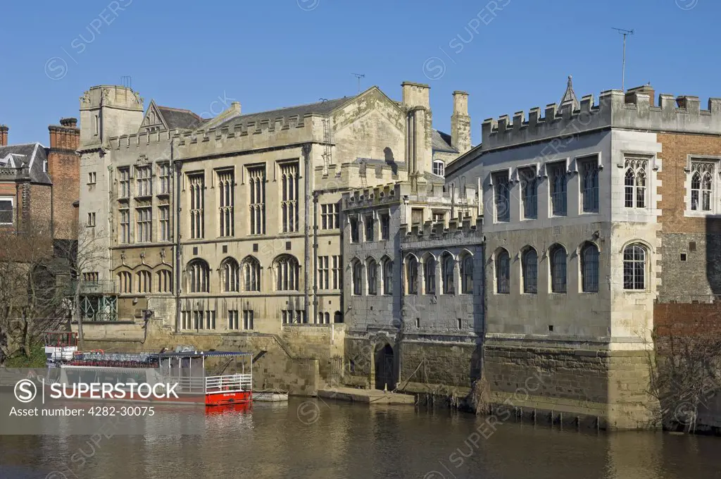 England, North Yorkshire, York. A sightseeing boat on the River Ouse outside The Guildhall, a Grade I listed building dating from the 15th century.