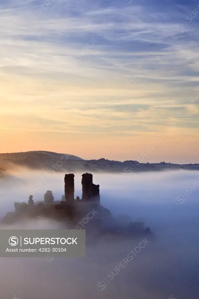 England, Dorset, Corfe Castle. Mist swirling around Corfe Castle guarding the only gap in the Purbeck Hills for 12 miles.