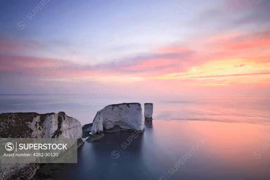 England, Dorset, Handfast Point. Sunrise at Old Harry Rocks on Dorset's Jurassic Coast world heritage site near Swanage.