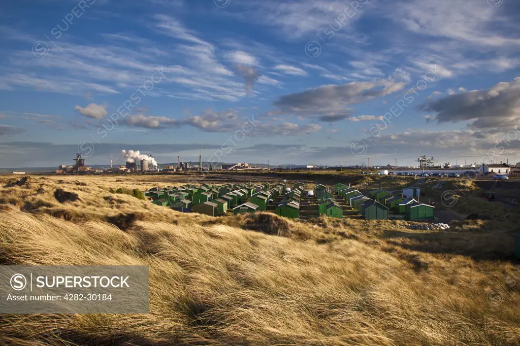 England, Redcar & Cleveland, Redcar. Steel Works and fishermans huts at South Gare.