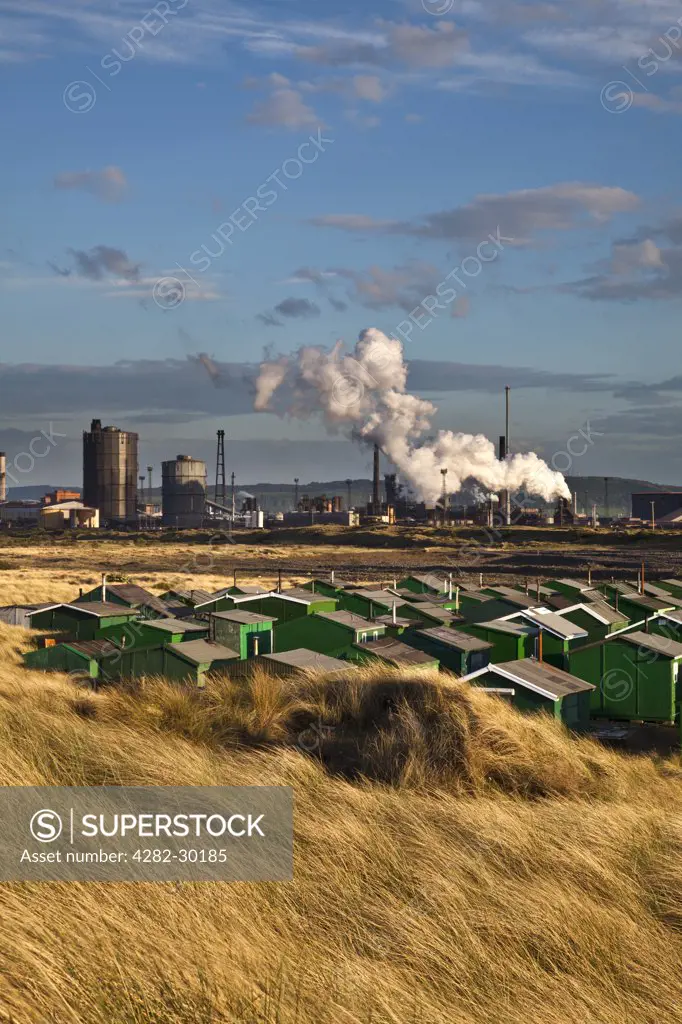 England, Redcar & Cleveland, Redcar. Steel Works and fishermans huts at South Gare