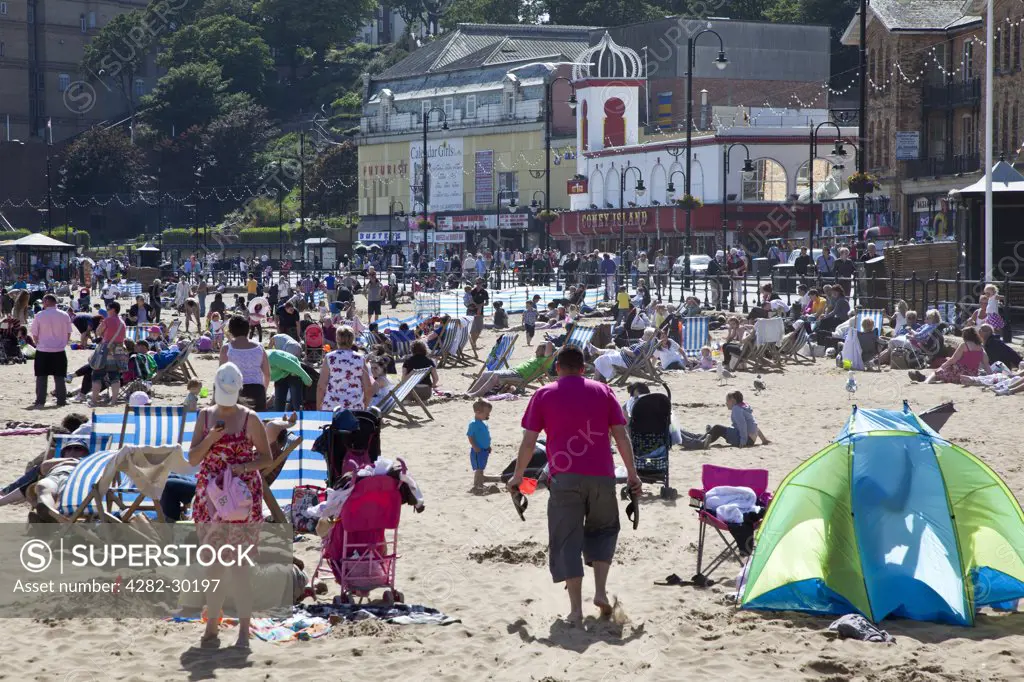 England, North Yorkshire, Scarborough. South Bay Beach in Scarborough packed with summer tourists.