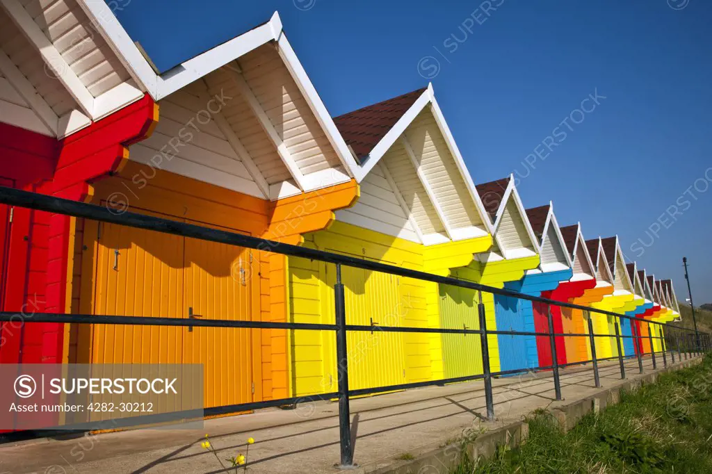 England, North Yorkshire, Scarborough. Colourful beach huts in North Bay, Scarborough.