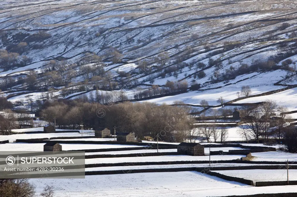 England, North Yorkshire, Thwaite. Snow covering the fields and hillside in Upper Swaledale during winter in the Yorkshire Dales National Park.