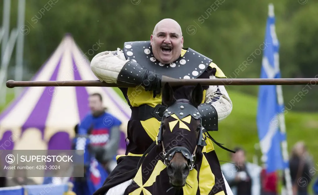Scotland, West Lothian, Linlithgow. A knight on horseback in a jousting competition at a medieval pageant based around events at Scotland's royal court in 1503. Party at the Palace was held at Linlithgow Palace as a part of Homecoming Scotland 2009.
