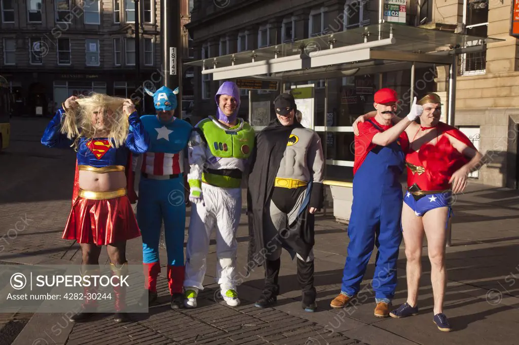 England, Tyne and Wear, Newcastle. A group of men dressed as super heros and animated characters on a stag weekend.