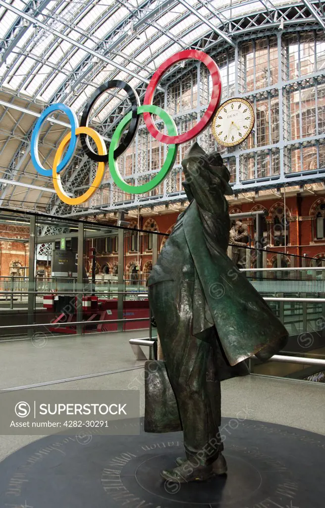 England, London, St Pancras. Sir John Betjeman statue and Olympic rings at St Pancras International Station.