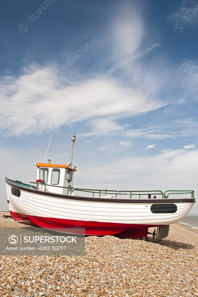England, Kent, Dungeness. A fishing boat on the shingle beach at Dungeness.