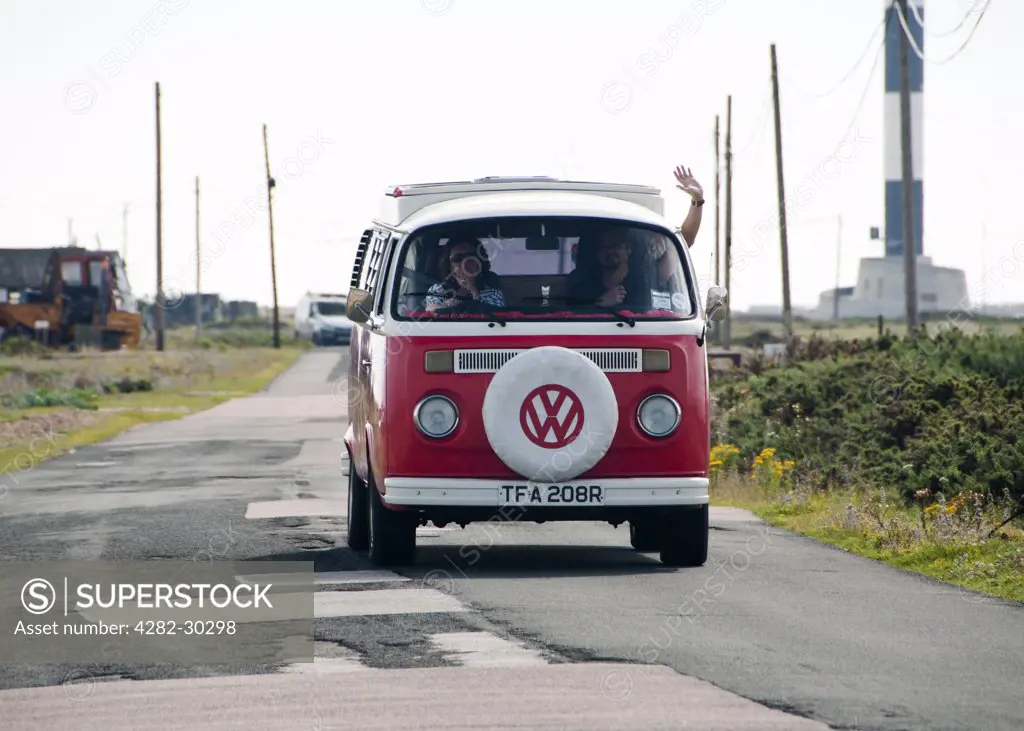 England, Kent, Dungeness. Tourists travelling in a VW camper van.