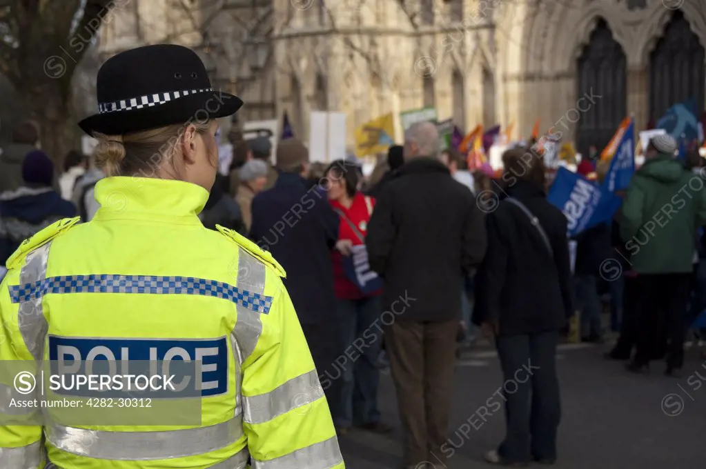 England, North Yorkshire, York. Police woman on duty at a protest by UNISON trade union members outside York Minster.