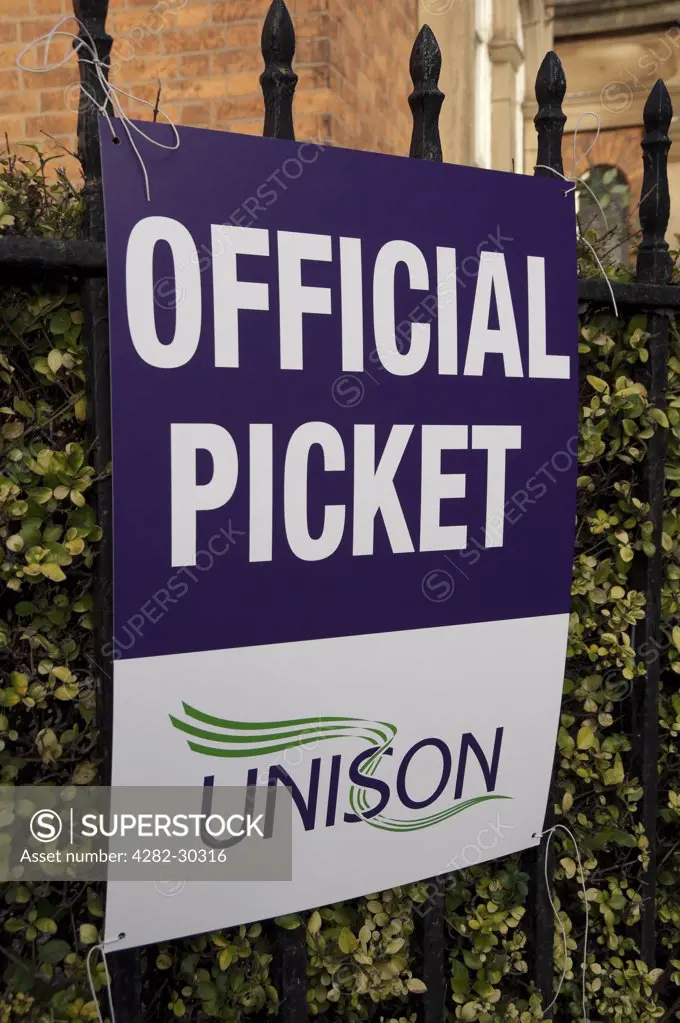England, North Yorkshire, York. UNISON trade union official picket banner tied to railings.