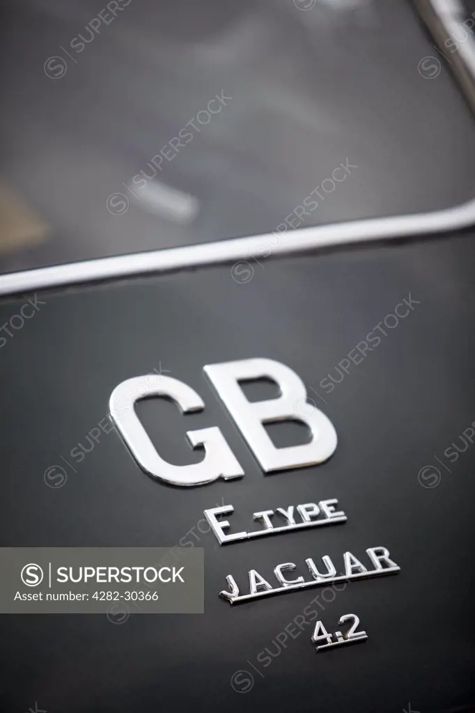 England, Northamptonshire, Silverstone. Type and model lettering on an E-type Jaguar on display at Silverstone Classic, an annual 3 day weekend classic motor racing festival with a wide range of family entertainment.