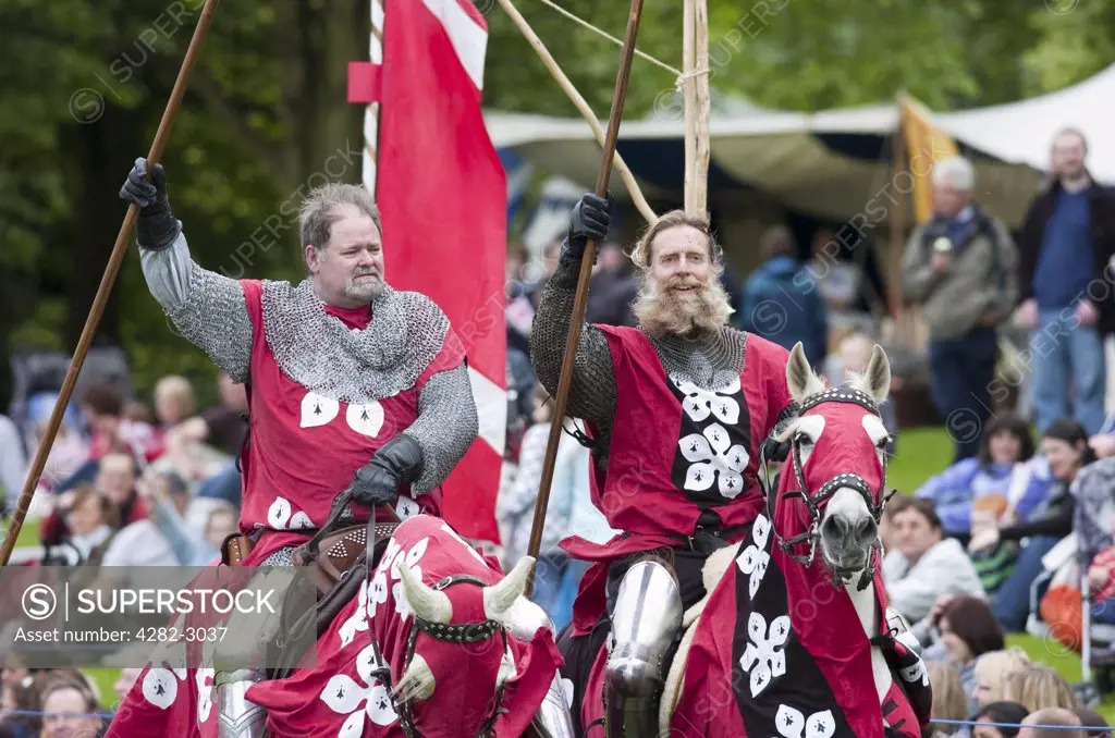 Scotland, West Lothian, Linlithgow. Knights on horseback in a jousting competition at a medieval pageant based around events at Scotland's royal court in 1503. Party at the Palace was held at Linlithgow Palace as a part of Homecoming Scotland 2009.