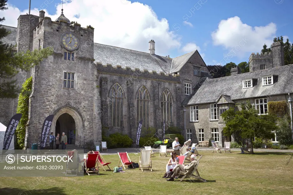 England, Devon, Dartington. People relaxing in deckchairs in the grounds of Dartington Hall at The Telegraph Ways With Words Literary Festival.
