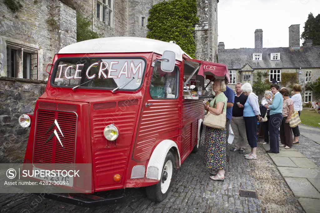 England, Devon, Dartington. People queuing for an ice cream from a vintage van at The Telegraph Ways With Words Literary Festival held at Dartington Hall.