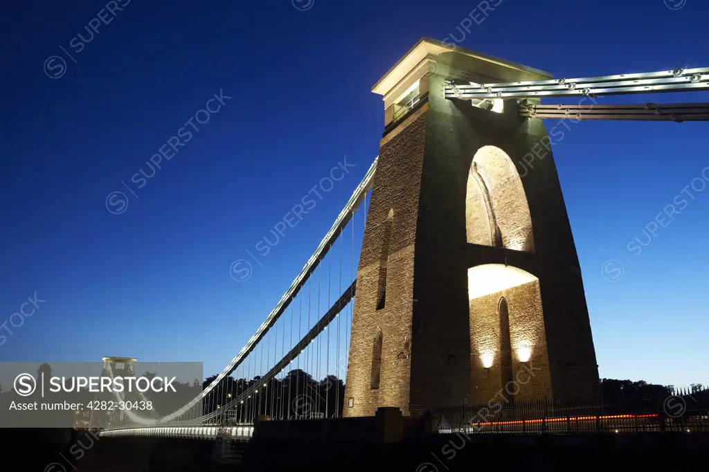 England, Bristol, Clifton. The Clifton Suspension Bridge spanning the Avon Gorge at night. The bridge was designed by Isambard Kingdom Brunel and completed in 1864, 5 years after his death.