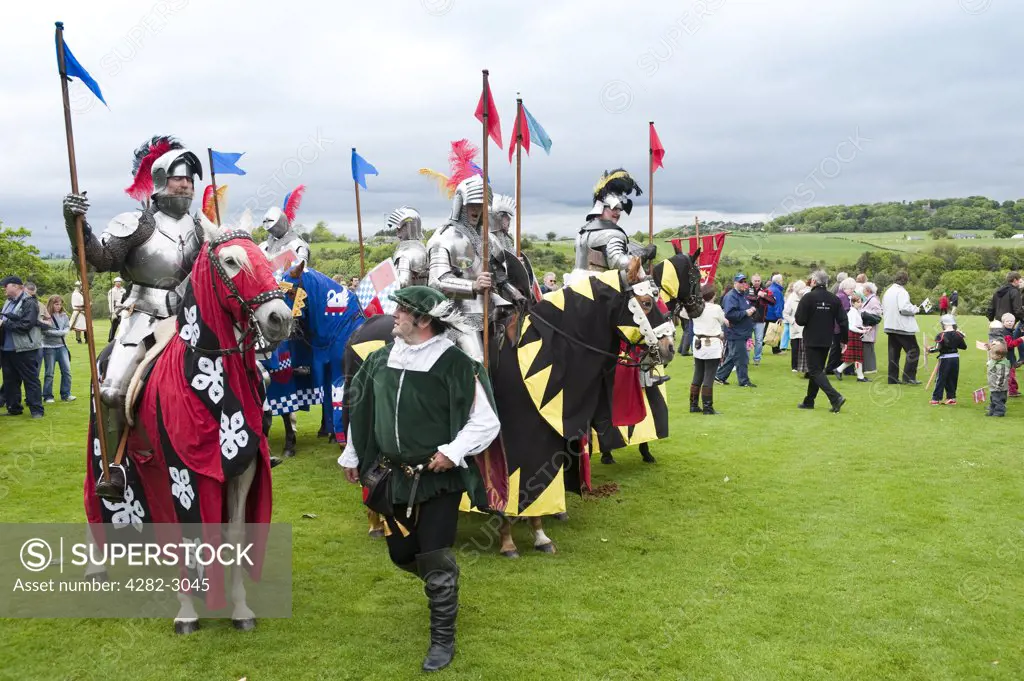 Scotland, West Lothian, Linlithgow. Armoured knights on horseback gather for a jousting competition at a medieval pageant based around events at Scotland's royal court in 1503. Party at the Palace was held at Linlithgow Palace as a part of Homecoming Scotland 2009.