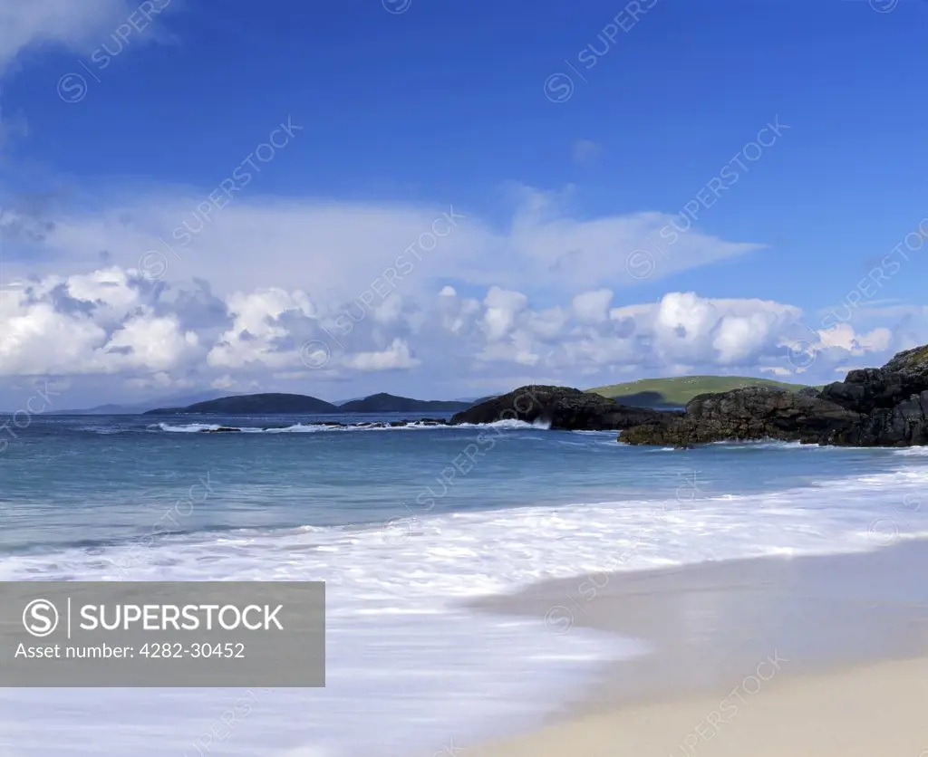 Scotland, Western Isles, Isle of Barra. Waves roll onto the sandy beach near Borgh on the tiny Hebridean island of Barra.