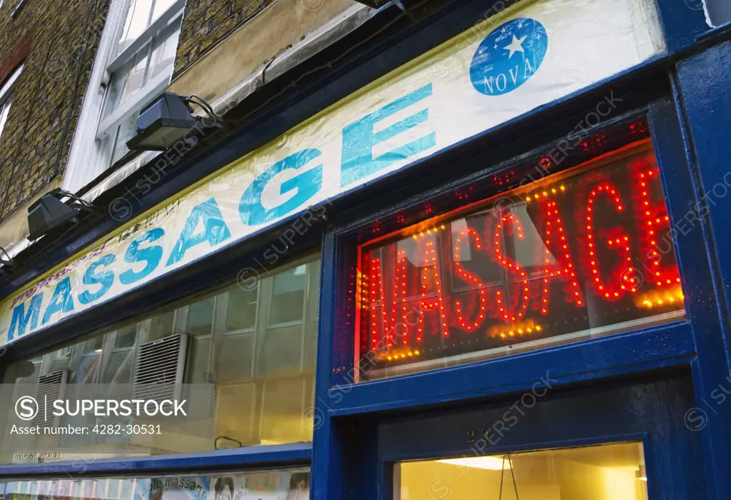 England, London, Westminster. Neon sign above the entrance to a massage parlour in Whitcomb Street, near Trafalgar Square.