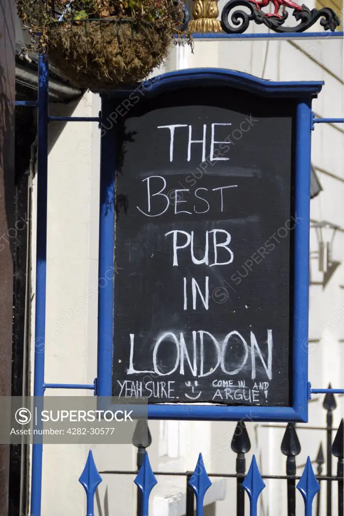 England, London, Kings Cross. Sarcastic comments on a sign outside a pub in Kings Cross proclaiming 'The Best Pub in London'.