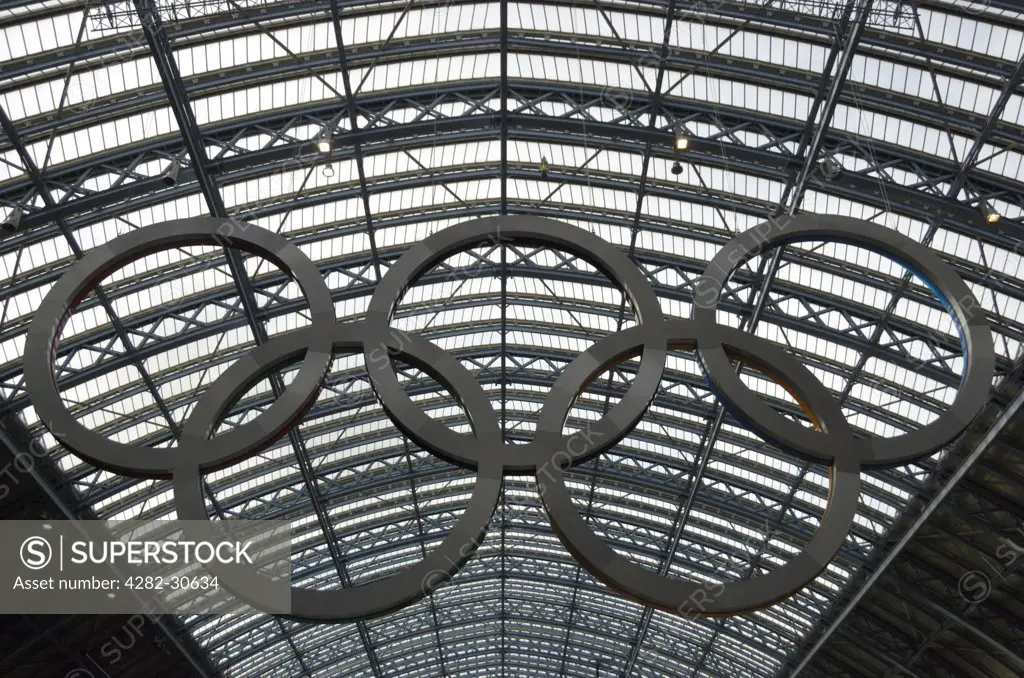 England, London, St Pancras. A giant set of Olympic rings hanging in St Pancras International Station.