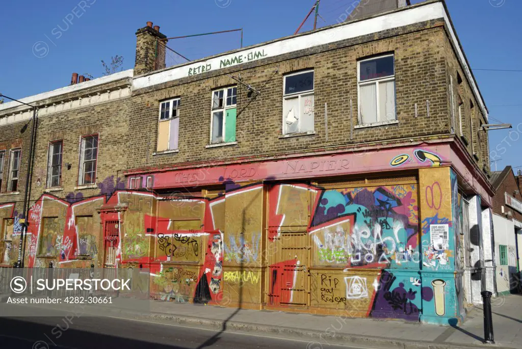 England, London, Hackney Wick. Graffiti covering the walls and boards of The Lord Napier, a derelict pub in Hackney Wick.