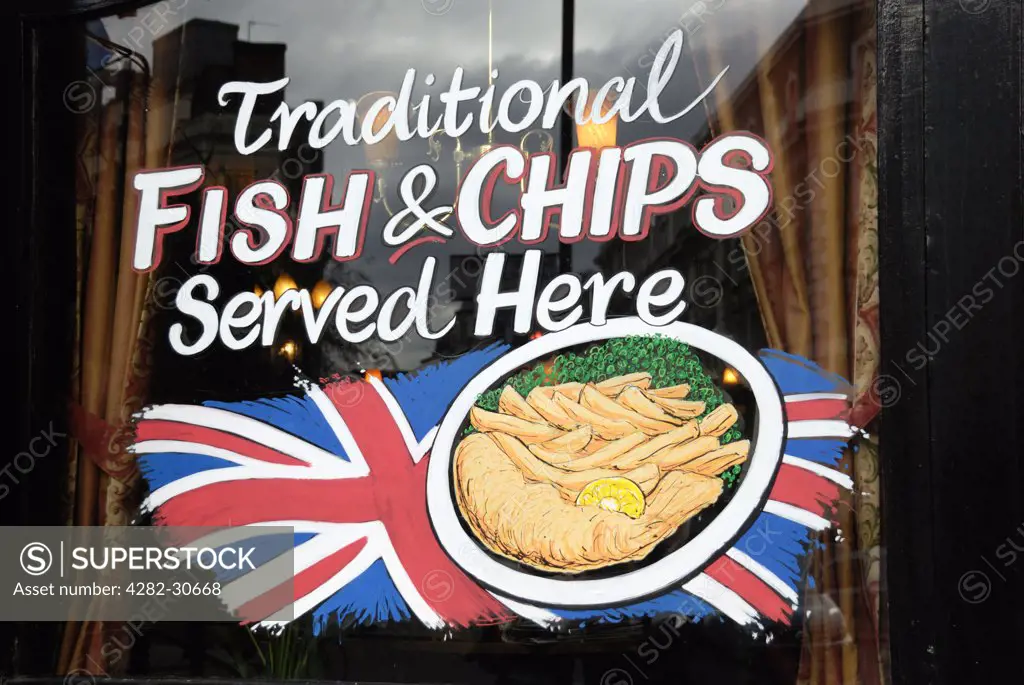 England, London, Covent Garden. Traditional Fish and Chips sign in the window of a London pub.