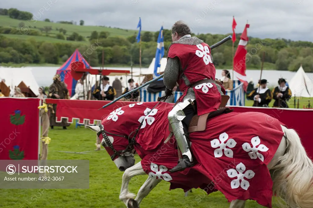 Scotland, West Lothian, Linlithgow. An armoured knight on horseback competing in an equestrian sport at a medieval re-enactment based around events at Scotland's royal court in 1503. Party at the Palace was held at Linlithgow Palace as a part of Homecoming Scotland 2009.
