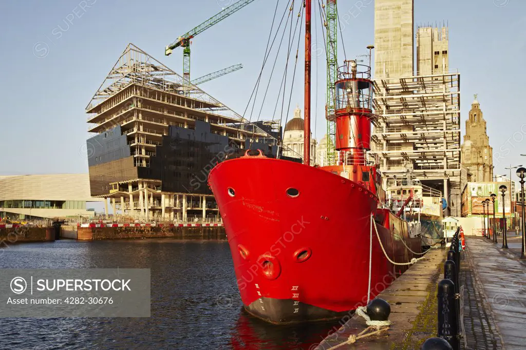 England, Merseyside, Liverpool. The Mersey Bar lightship Planet moored in Canning Dock surrounded by new construction.