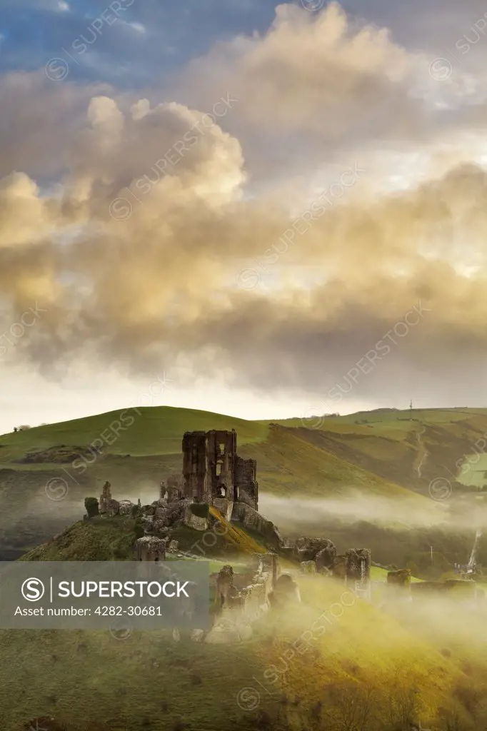 England, Dorset, Corfe Castle. The ruins of Corfe Castle rising through the morning mist.
