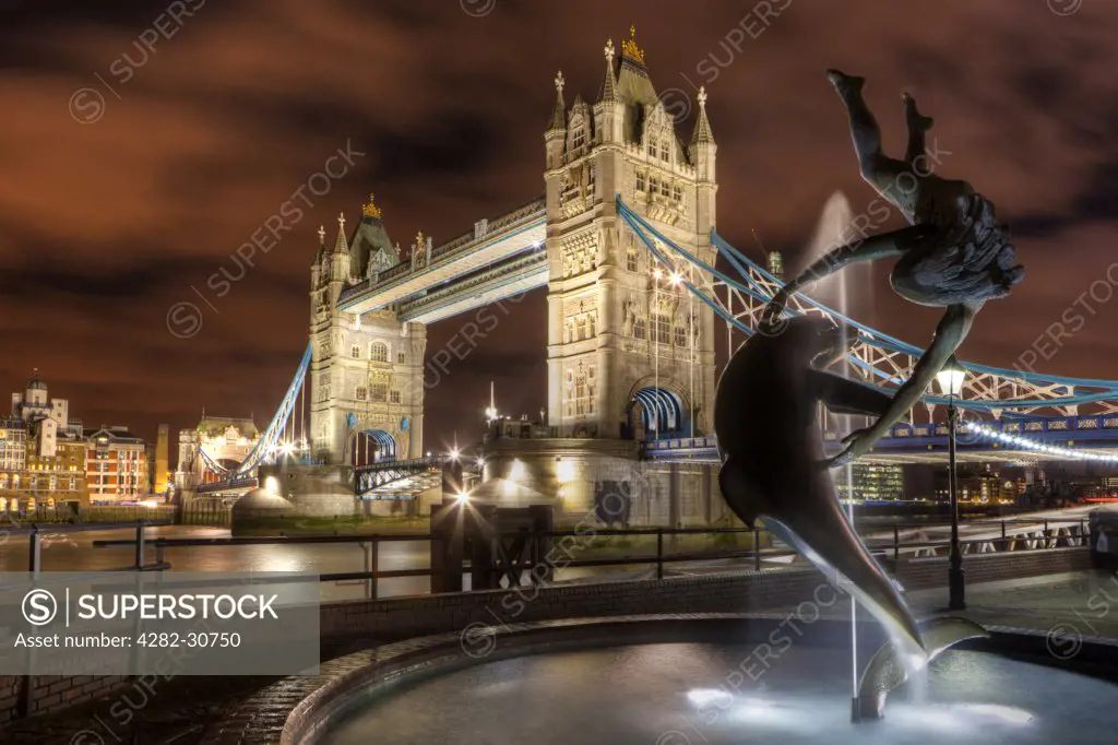 England, London, Tower Bridge. David Wynne's 'Girl with a Dolphin' statue on the North bank of the River Thames by Tower Bridge.
